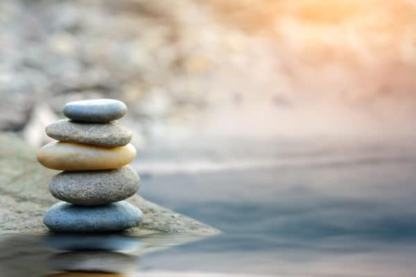 Balance stone with spa on river coast